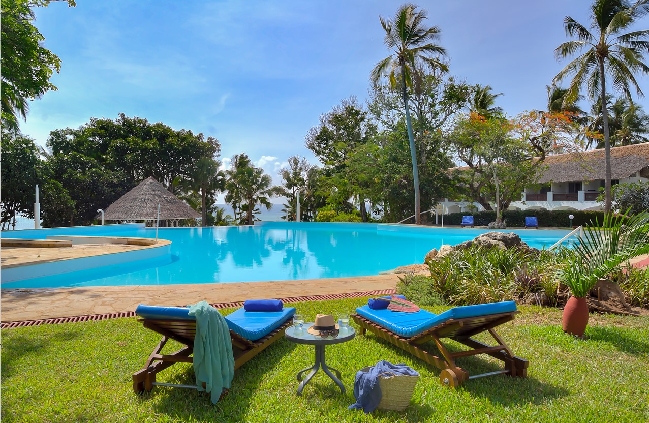 View of Leisure Lodge Beach and Golf Resort with palm trees and Indian Ocean